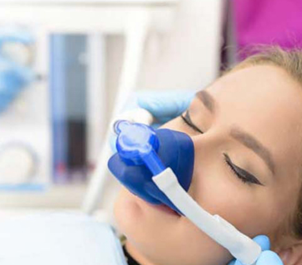 Woman under sedation with mask on nose